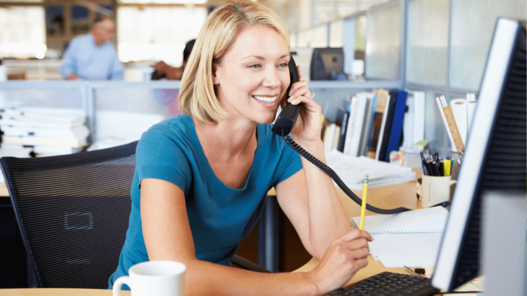 Woman On Phone In Busy Modern Office