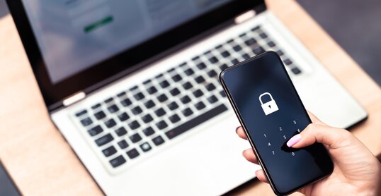 Phone password lock for mobile cyber security or login verification passcode in online bank app. Data privacy and protection from hacker, identity thief or cybersecurity threat. Laptop and smartphone.