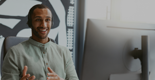 Handsome african businessman working computer while sitting in modern coworking