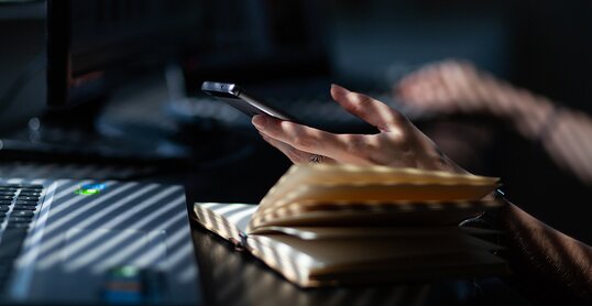 woman hands using smartphone, home office background, social media influencer