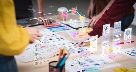 Close up ux developer and ui designer use augmented reality brainstorming about mobile app interface wireframe design on desk at modern office.Creative digital development agency