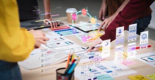 Close up ux developer and ui designer use augmented reality brainstorming about mobile app interface wireframe design on desk at modern office.Creative digital development agency