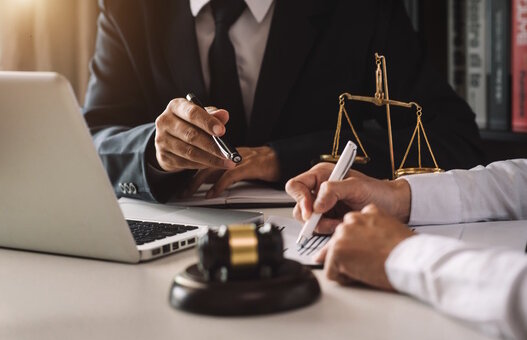 business people and lawyers discussing contract papers sitting at the table. Concepts of law, advice, legal services. in morning light