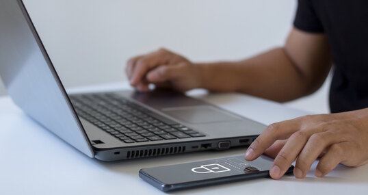 Cyber security concept. Business people type passwords and press the check button on a mobile smartphone application connect to the database via a data security system technology on display at office