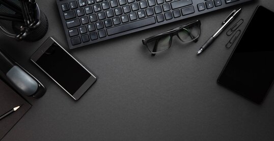 Office Supplies With Computer Keyboard On Gray Desk