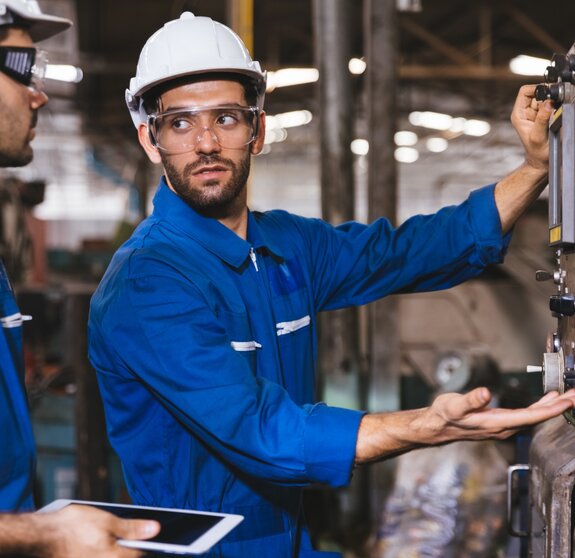 Group of Industrial factory maintenance engineers inspect relay protection system of machinery. Industry, Maintenance, Engineering and construction concept.