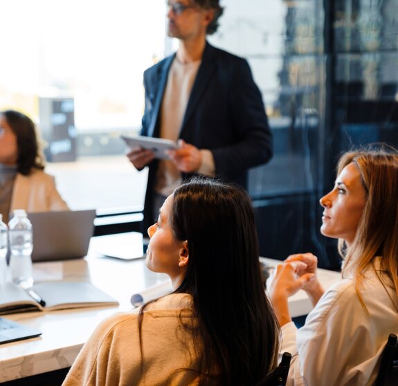 Different age colleagues examining presentation during offline meeting