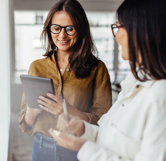 Business women standing in an office and discussing their ideas