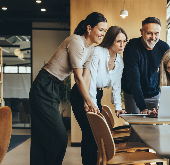 Group of businesspeople using a laptop together