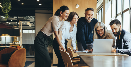 Group of businesspeople using a laptop together