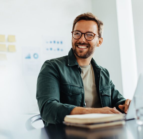 Happy business man listening to a discussion in an office