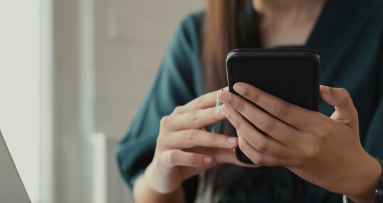 Close up of woman using mobile phone.